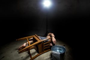 Prisoner being punished with cruel interrogation technique of waterboarding
